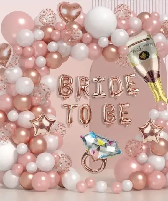Bride to be balloon decoration with light rose gold white and transparent balloons, champagne bottle foil, ring foil, bride to be banner, rose gold heart foils and floor balloons by Event Experts UAE in Dubai Abu Dhabi Sharjah Ajman Ras Al Khaimah Fujairah Umm Al Quwain