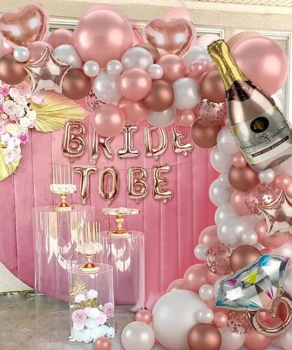 Bride to be balloon decoration with rose gold silver white and heart balloons, bride to be foil banner, champagne bottle foil, ring foil, rose gold heart foils and artificial leaves by Event Experts UAE in Dubai Abu Dhabi Sharjah Ajman Ras Al Khaimah Fujairah Umm Al Quwain