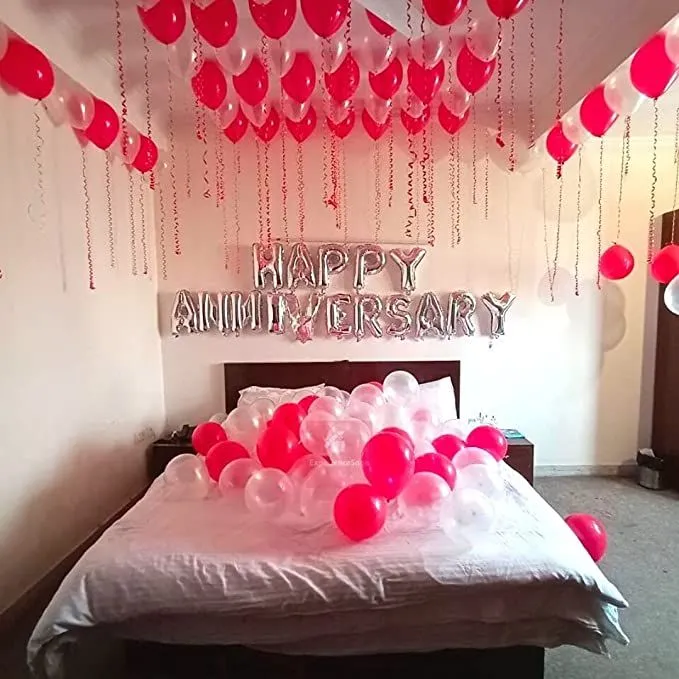 Anniversary balloon decoration with 50 red balloons, 50 silver balloons, transparent balloons, and a Happy Anniversary foil balloon in Dubai, UAE by Event Experts.