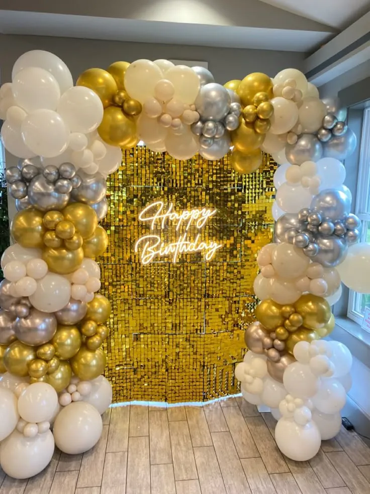 Golden backdrop birthday decoration with golden, white and cream balloons and Happy Birthday wall sign in Dubai, UAE by Event Experts.