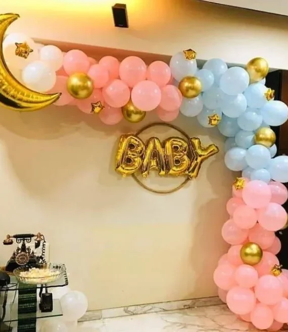 Baby shower half arch balloon decoration with light pink blue and golden balloons, small star balloons, moon foil, baby foil banner and baby shower setup by Event Experts UAE in Dubai Abu Dhabi Sharjah Ajman Ras Al Khaimah Fujairah Umm Al Quwain