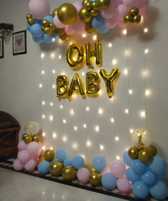 Simple baby shower balloon decoration with light pink blue and golden balloons, Oh Baby foil, backdrop with lights and baby shower balloon setup by Event Experts UAE in Dubai Abu Dhabi Sharjah Ajman Ras Al Khaimah Fujairah Umm Al Quwain