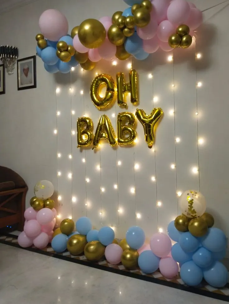 Simple baby shower balloon decoration with light pink blue and golden balloons, Oh Baby foil, backdrop with lights and baby shower balloon setup by Event Experts UAE in Dubai Abu Dhabi Sharjah Ajman Ras Al Khaimah Fujairah Umm Al Quwain