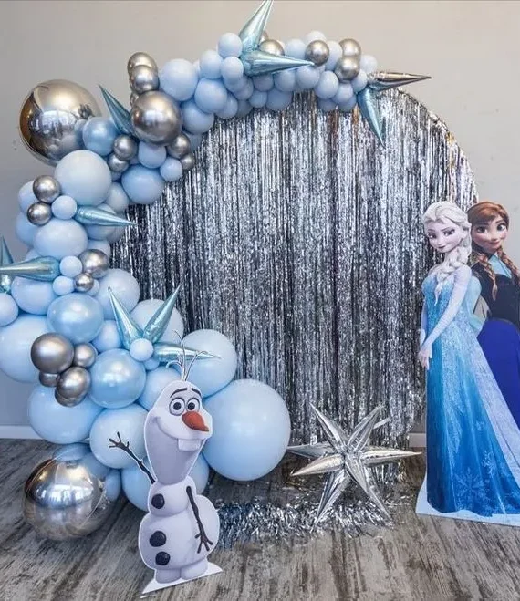 Frozen theme round frame balloon decoration setup with pastel blue, silver balloons, silver shimmer backdrop, Frozen character cutouts, and blue and silver star foil balloons.