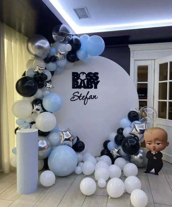 Baby Boss theme round arch backdrop balloon setup with black, sky blue, silver, white balloons, transparent balloons, foil star balloons, Baby Boss foil balloon, and white cake table decoration.