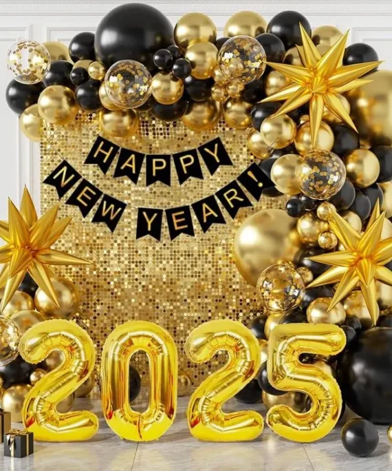 Happy New Year 2027 golden shimmer balloon decoration setup with black, gold, and transparent confetti balloons, gold foil star balloons, 2027 number foil balloons, Happy New Year silver foil banner, floor balloons, and white round cake table.